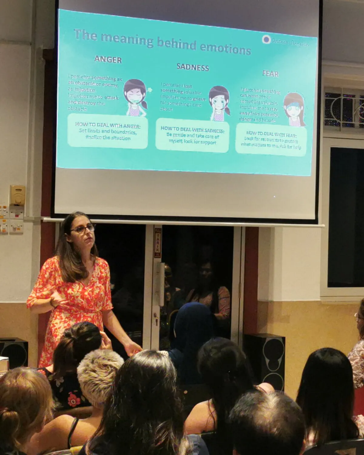 Andrea giving a talk to a full room